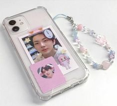 an iphone case with a photo and beaded lanyard attached to the back of it