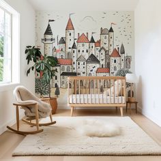 a baby's room with a wall mural and rocking chair in front of the crib