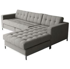 a gray couch and ottoman sitting next to each other