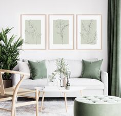 a living room filled with furniture and paintings on the wall