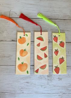 three tags with fruits and vegetables painted on them