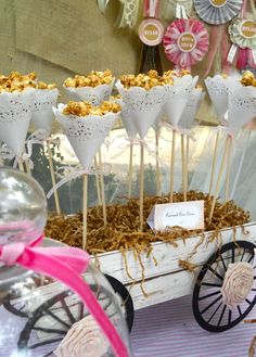 an old fashioned wagon filled with popcorn and marshmallows