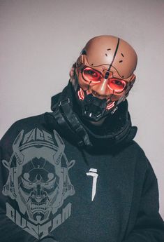 a man wearing a hoodie and mask with red glasses