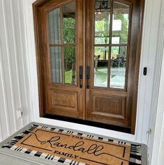 the front door is decorated with a welcome mat