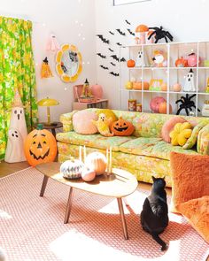a living room decorated for halloween with pumpkins and other decorations on the walls,
