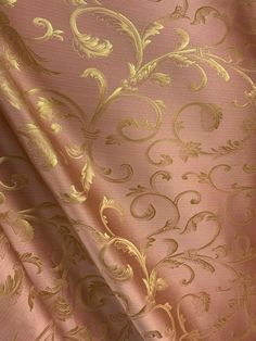 a pink and gold wallpaper with an intricate design on it's side,