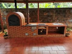 an outdoor kitchen made out of bricks and wood