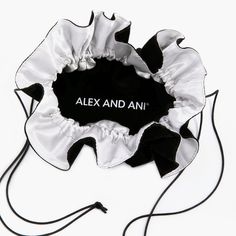 a black and white flower with the name alex and ani on it