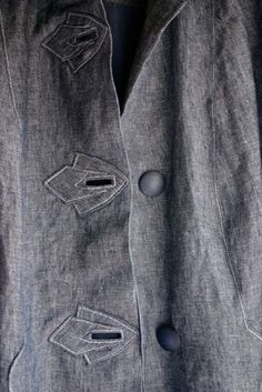 a jacket with buttons and holes on it