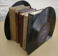 an old record book holder is holding several books