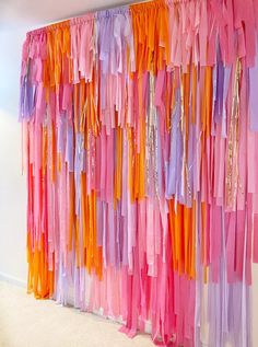 colorful streamers are hanging on the wall