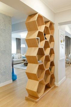 a book shelf made out of wooden cubes in a living room with hardwood floors