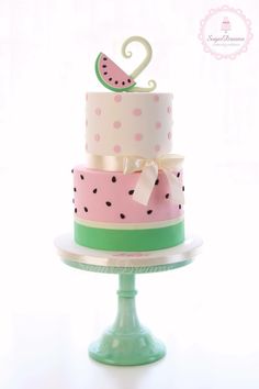 a three tiered cake with polka dots and a number two on top