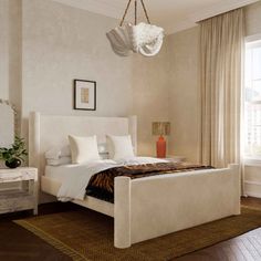 a large white bed sitting in a bedroom on top of a wooden floor next to a window