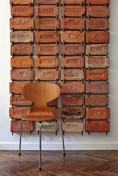 a wooden chair sitting in front of a wall