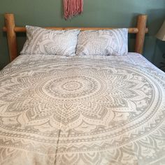 a bed with a white and grey bedspread