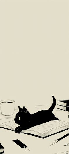 a black cat laying on top of an open book next to a cup and pen