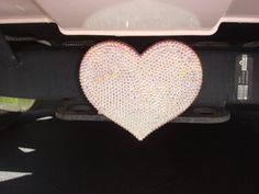 a heart - shaped object on the back of a car