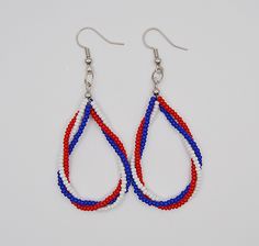 red, white and blue beaded tear shaped earrings with silver ear wires hanging from hooks