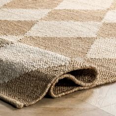 an area rug on the floor that has been made with natural wool and jute