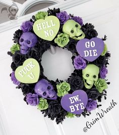 a wreath decorated with skulls and flowers on the front door to say hell no, go bye