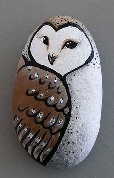 an owl painted on top of a rock