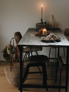 a dining room table with food on it and a lit candle in the corner above