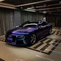 a purple and blue car parked in a garage