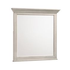 a white mirror sitting on top of a wall