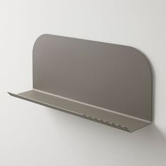 a metal shelf mounted to the side of a wall