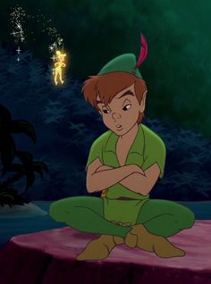 tinkerbell sitting on the ground with her arms crossed in front of her face