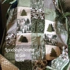a quilted blanket with trees on it and the words love sewn seams next to it