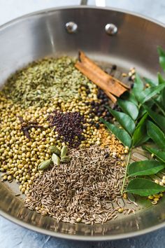 spices and herbs in a pan on a table