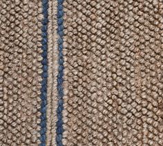 a close up view of the side of a rug with blue and beige stripes on it