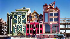 a bus is parked in front of some colorful buildings