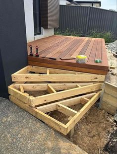 a wooden deck being built with tools on it