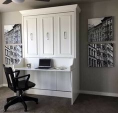 a home office with white cabinets and black chair