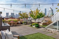 an outdoor kitchen and dining area on top of a roof