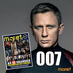 a man holding up a magazine cover with an image of james bond on the front