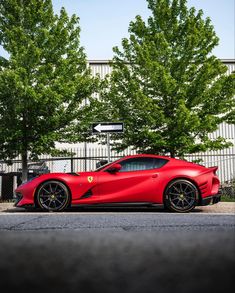 a red sports car parked in front of a building