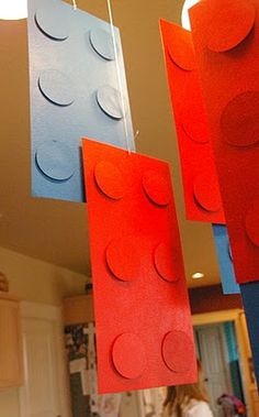 some red and blue lego blocks hanging from the ceiling