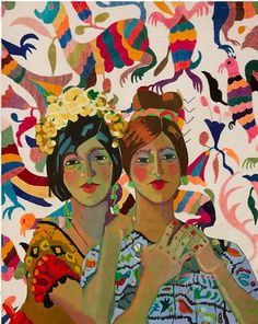 two women are standing in front of a colorful background with birds and flowers on it