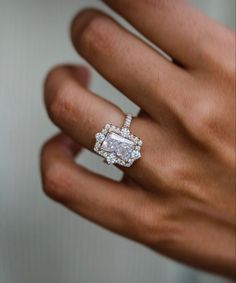 a woman's hand with a diamond ring on it