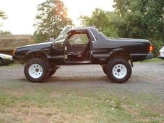 a black pick up truck parked in a parking lot