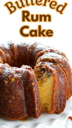 a bundt cake on a white plate with the words, buttered rum cake