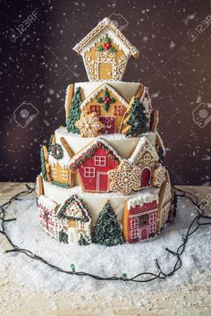 a decorated christmas cake on a table with snow falling around it stock photo - 9579