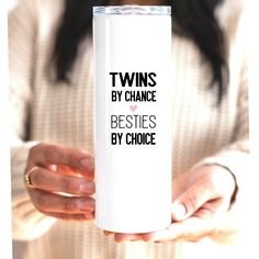 a woman holding a white coffee mug with the words twins by chance besties by choice