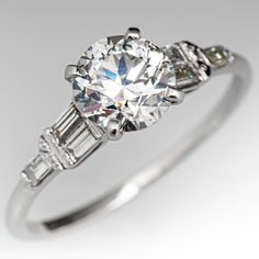 an engagement ring with three baguets on the side