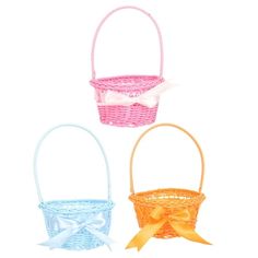 three different colored baskets with bows on them