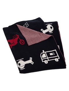 two black towels with red and white designs on them, one is folded up to the side